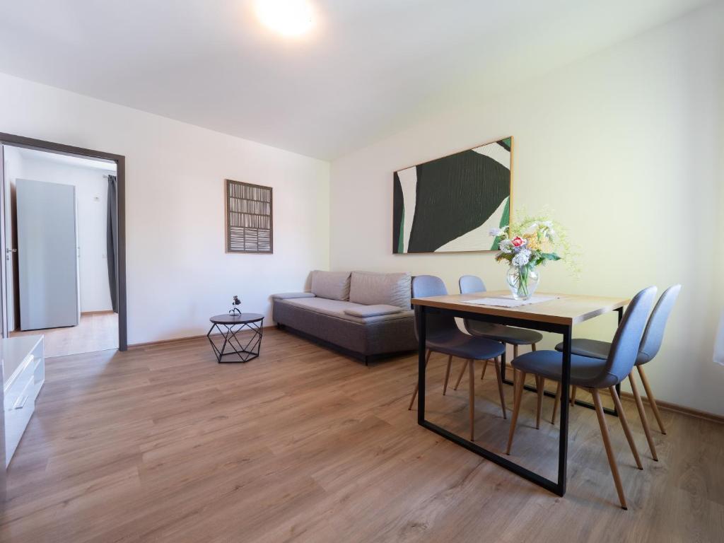 a living room with a table and a couch at Cozy apartment with breakfast on request 1 in Pula