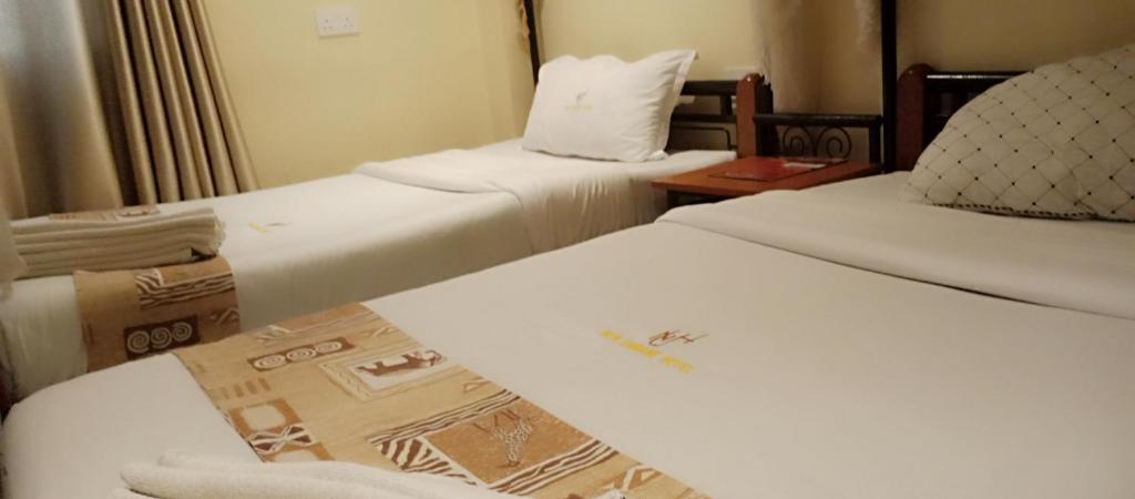 Postel nebo postele na pokoji v ubytování Urbane Hotel Urbane Plaza