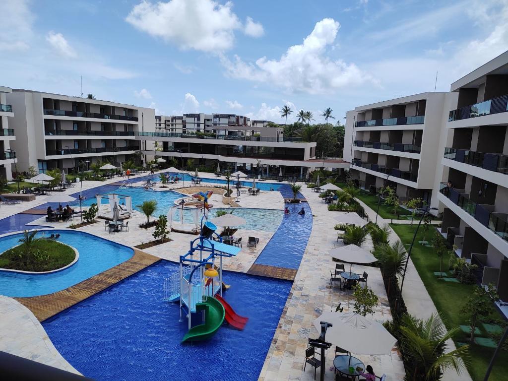 a resort with a water park with slides and rides at Malia Beach Muro Alto 300 Metros Do Mar in Porto De Galinhas