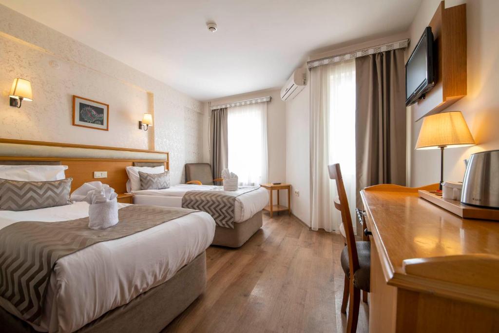 Postel nebo postele na pokoji v ubytování Çanak Hotel