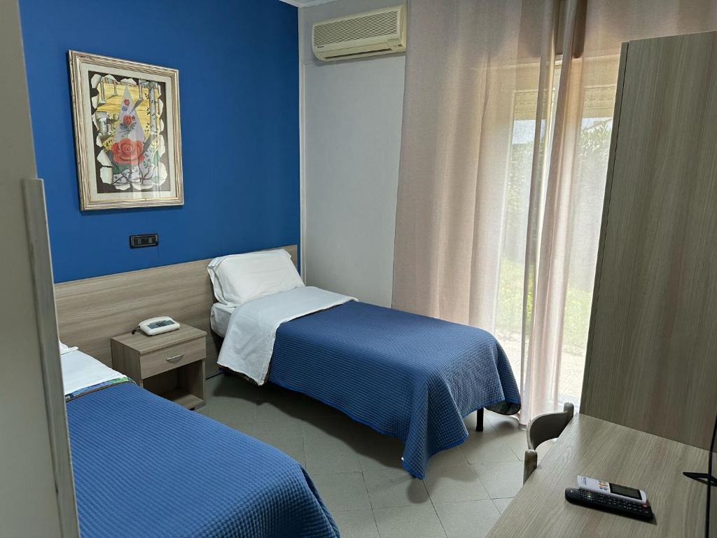 Postel nebo postele na pokoji v ubytování Hotel Costa Jonica
