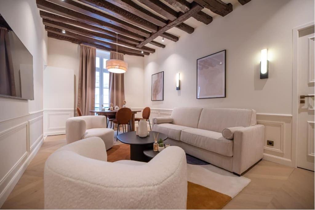un salon avec un canapé, des chaises et une table dans l'établissement Luxury one bedroom flat near Le Louvre I, à Paris
