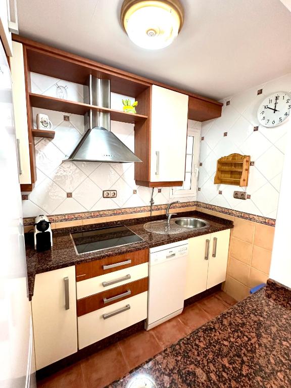 a kitchen with a sink and a stove at Apartamento a pie de playa en El Portil in El Portil