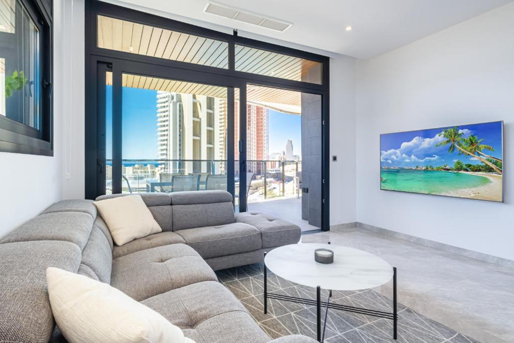 a living room with a couch and a table at Sunset Waves IV by Terreta Rentals in Benidorm