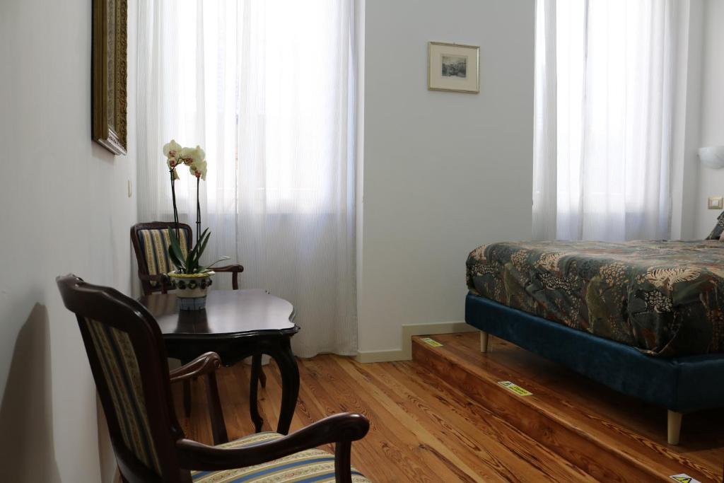 Postel nebo postele na pokoji v ubytování Casa Elli Serbelloni 12