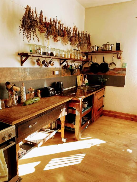 a kitchen with a large wooden table with pots and pans at Studniska Country Estate in Studniska