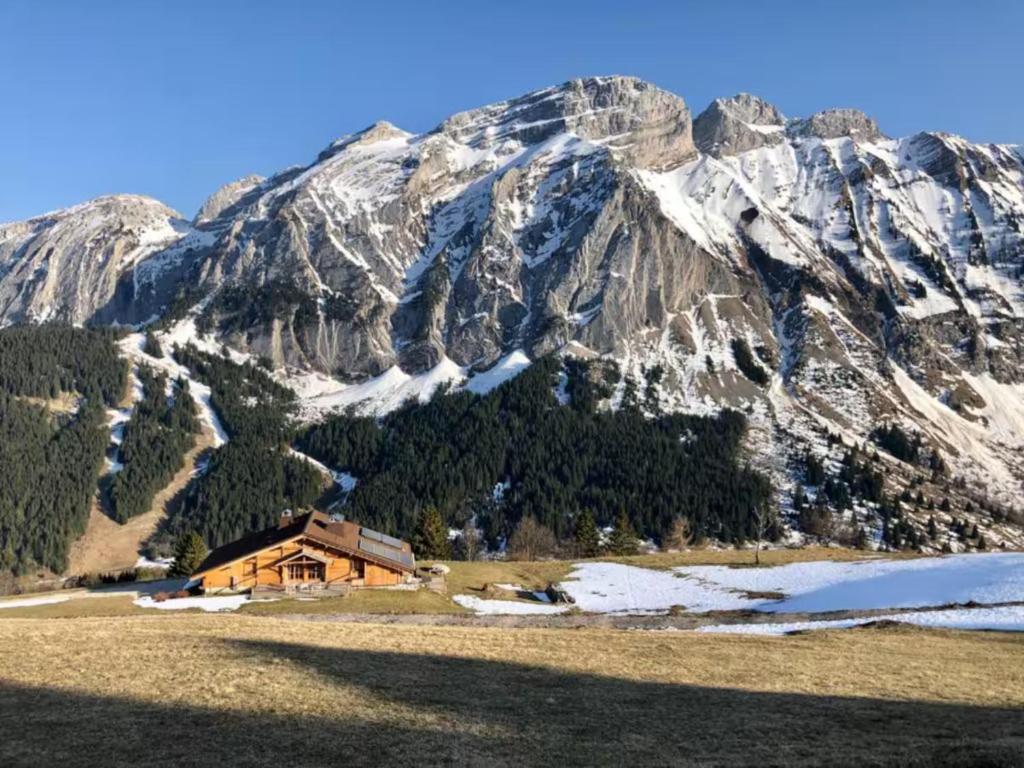 a cabin in front of a snow covered mountain at Grand Chalet - Coeur de la montagne in Mont-Saxonnex
