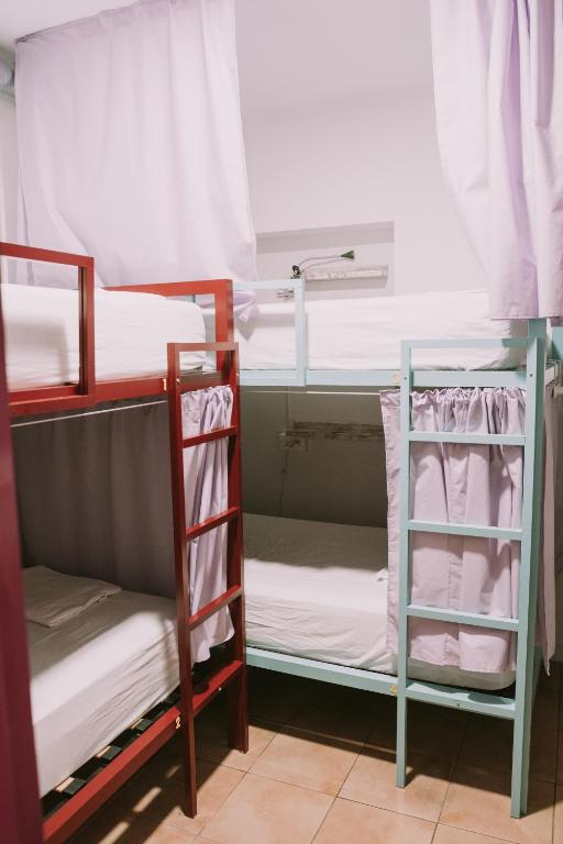 two bunk beds in a dorm room at Kite & Surf Nomad House in Las Palmas de Gran Canaria