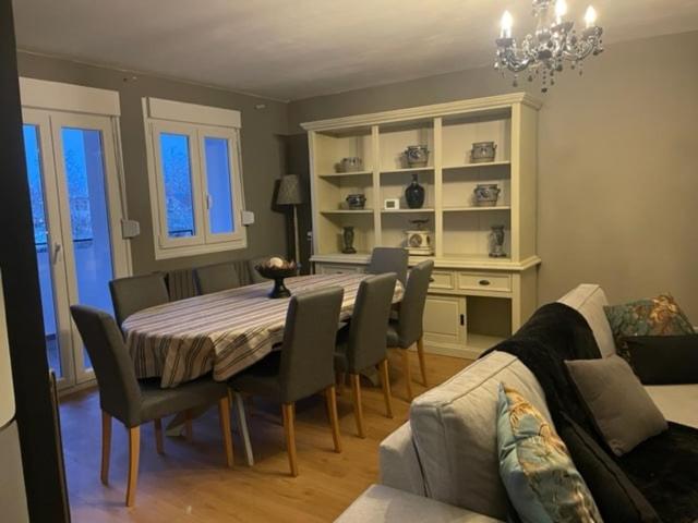 a dining room with a table and chairs and a couch at Gite Nicole in Jeuxey