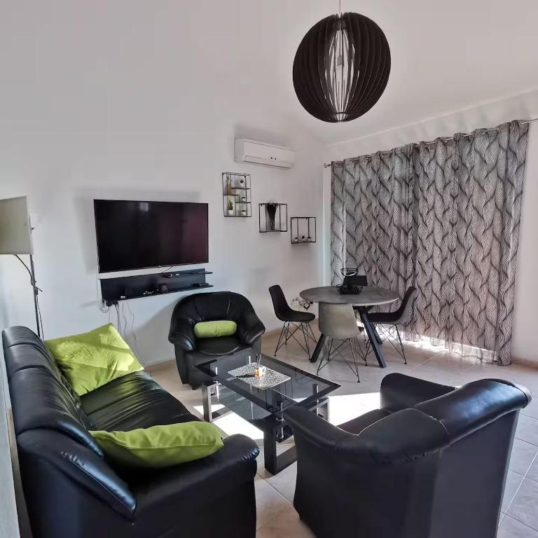 a living room with a couch and chairs and a table at Andromeda Hideaway in Polis Chrysochous
