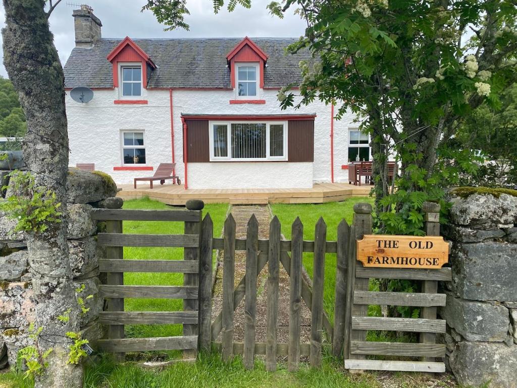 a gate to a house with a sign on it at The old Farmhouse Minutes from lochness in Drumnadrochit