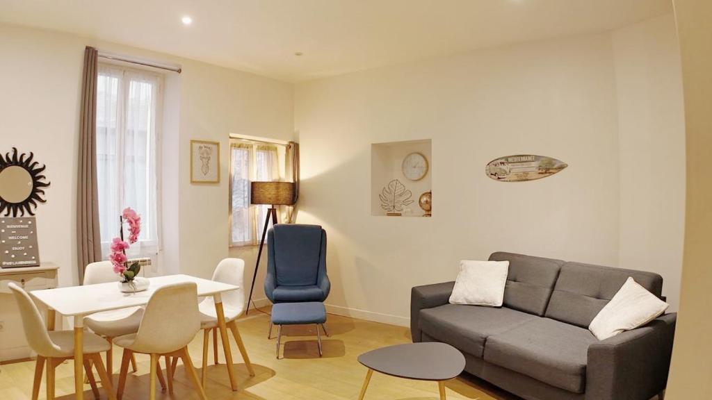 un salon avec un canapé et une table dans l'établissement L'Escapade, appartement Cosy au Coeur de Grasse, à Grasse