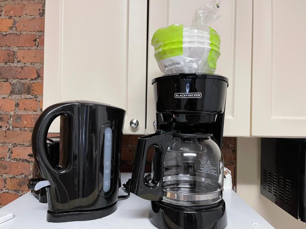 a black coffee maker sitting on top of a counter at Nestel Nest 1 bedroom apartment in New York