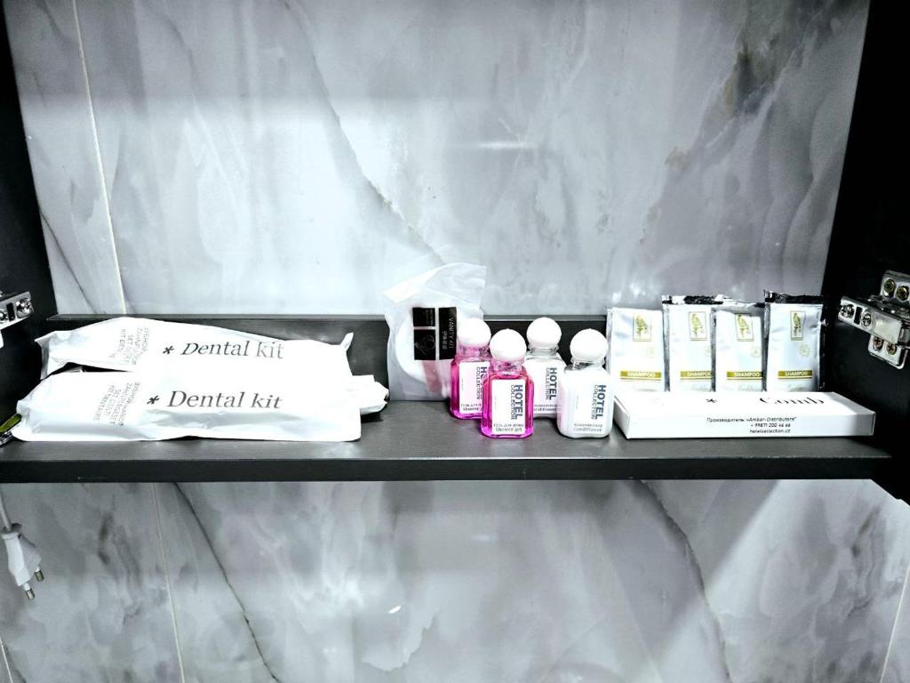 a shelf with products on it in a bathroom at Golden house deluxe 2 in Bukhara