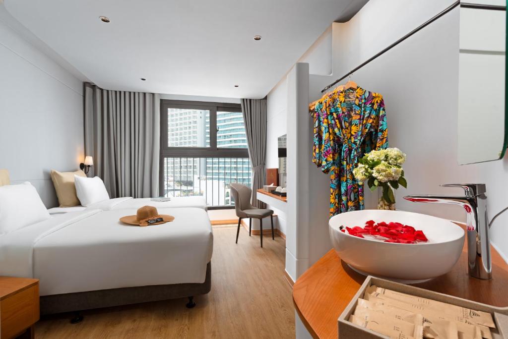 Giường trong phòng chung tại Seaside Boutique Hotel Nha Trang Beach