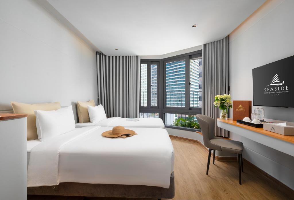 Postel nebo postele na pokoji v ubytování Seaside Boutique Hotel Nha Trang Beach