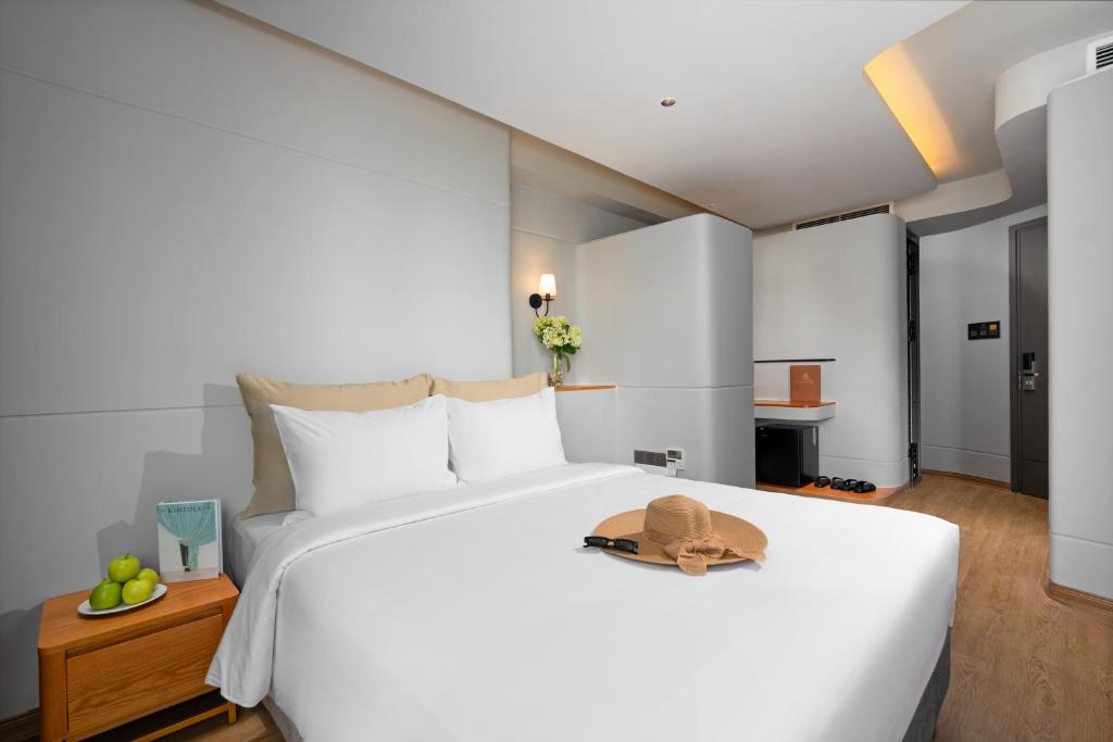 Giường trong phòng chung tại Seaside Boutique Hotel Nha Trang Beach