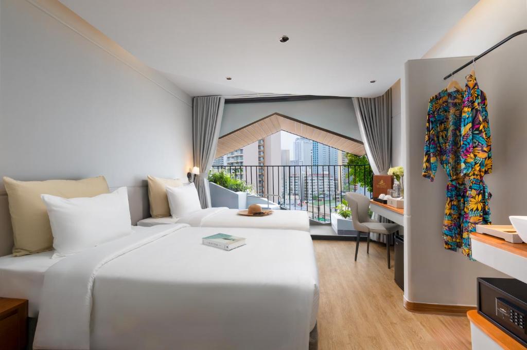 Giường trong phòng chung tại Seaside Boutique Hotel Nha Trang Beach