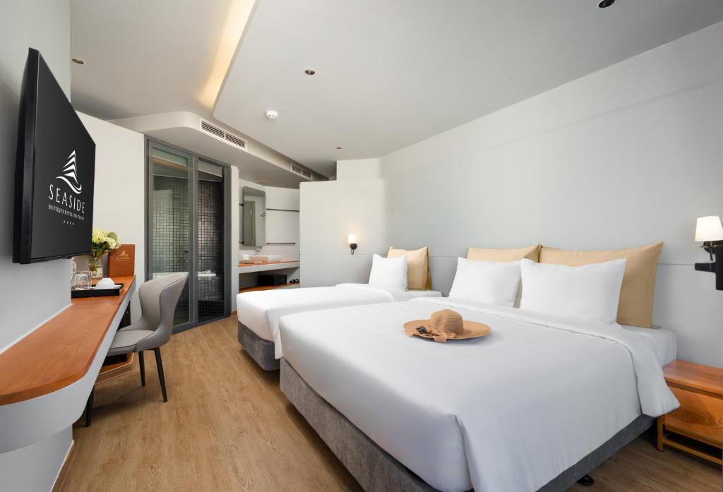 Postel nebo postele na pokoji v ubytování Seaside Boutique Hotel Nha Trang Beach