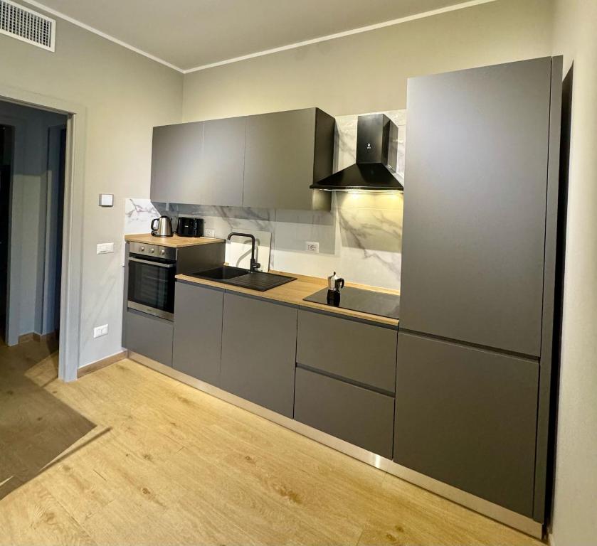 a kitchen with gray cabinets and a sink at Casa Magenta Apartment 4 in Valeggio sul Mincio