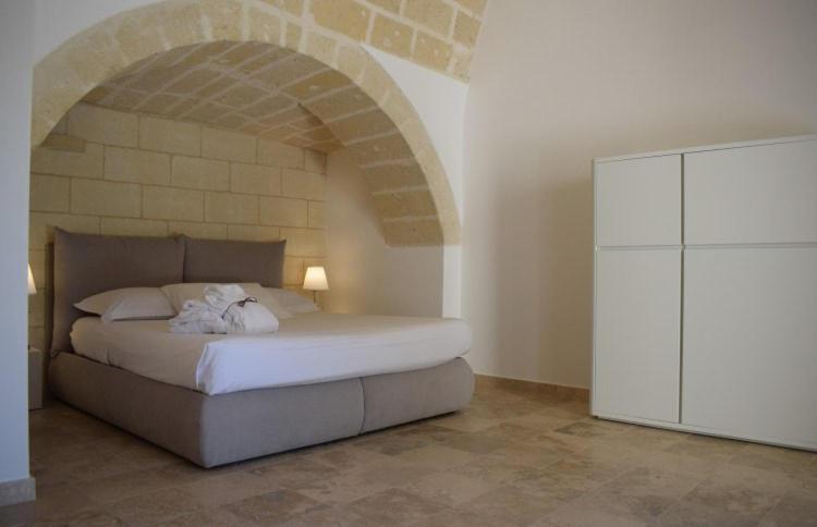 sypialnia z łóżkiem i łukowym sufitem w obiekcie Residence Masseria Santa Lucia w mieście Matera