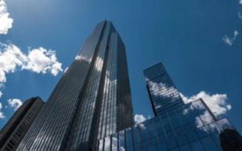 a tall glass building in front of a blue sky at Stay One Chicago in Chicago