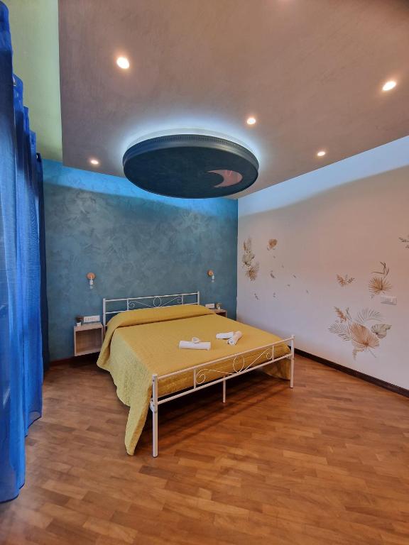 a bedroom with a bed and a blue wall at Moonlight Apartment in Fiumicino