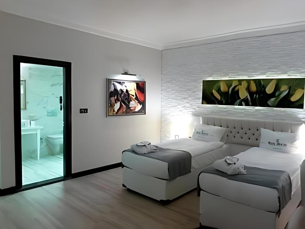 Postel nebo postele na pokoji v ubytování Real House Hotel