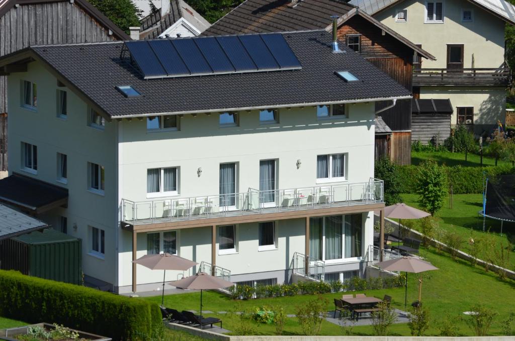 a house with solar panels on the roof at Apartment Haus Van der Leij in Russbach am Pass Gschütt