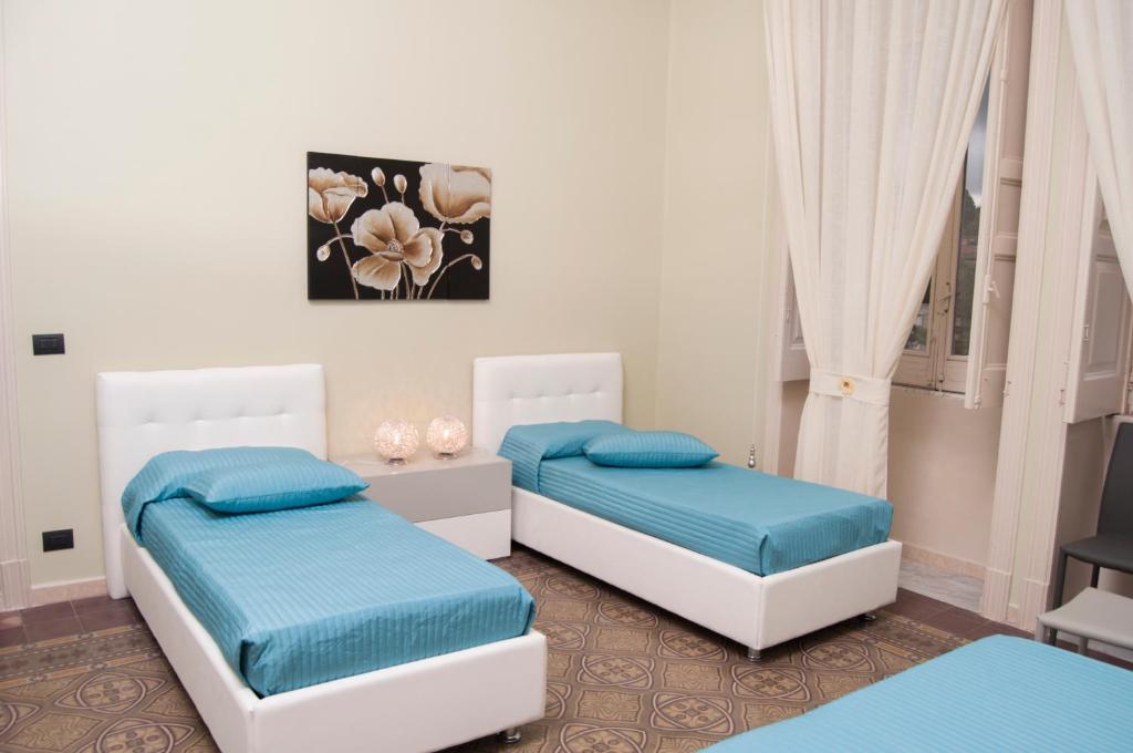Łóżko lub łóżka w pokoju w obiekcie B&B Villa Roma