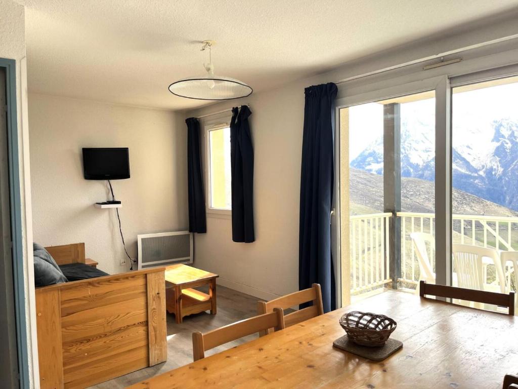 a living room with a table and a large window at Résidence Balcons Du Soleil 1 - T3/8pers BALCONS DU SOLEIL 30-Peyresourde MAE-4644 in Germ