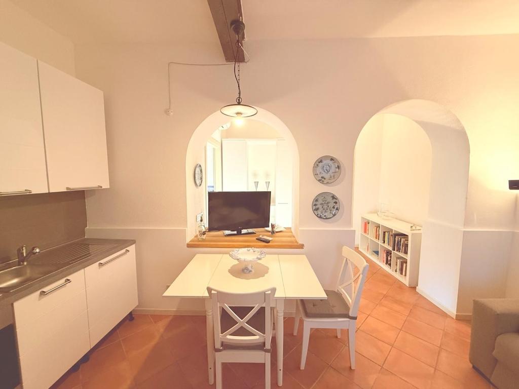 Una cocina con una mesa con una computadora encima. en Alle Albere - Verona - Bussolengo, en Bussolengo