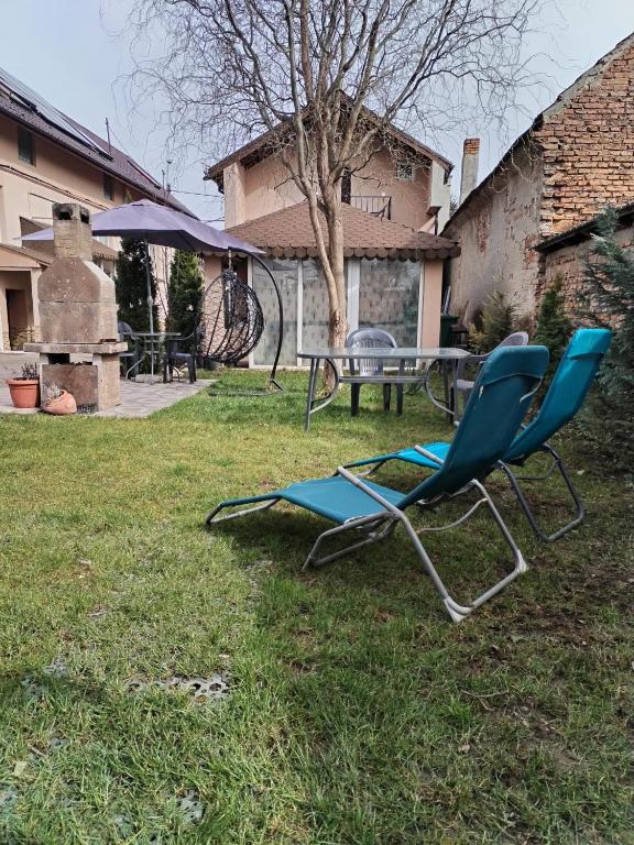 a pair of chairs and a table in a yard at Old Country Sight in Prejmer