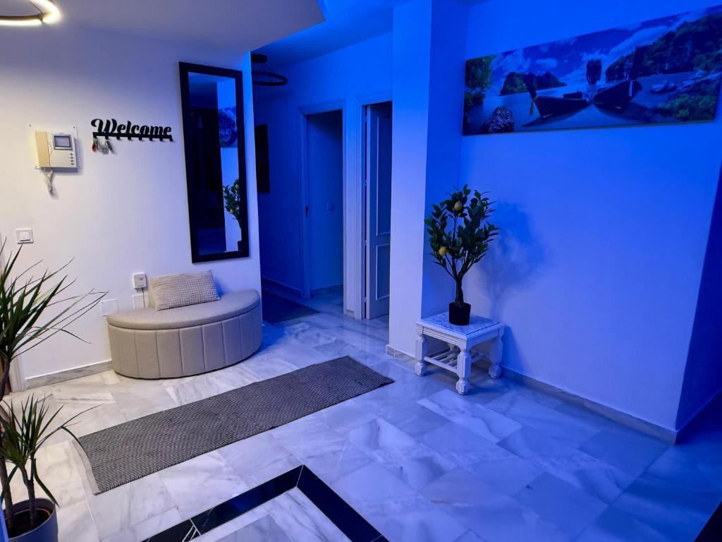 a blue room with a couch and a table at Playa Dona Sofia Bella in Fuengirola