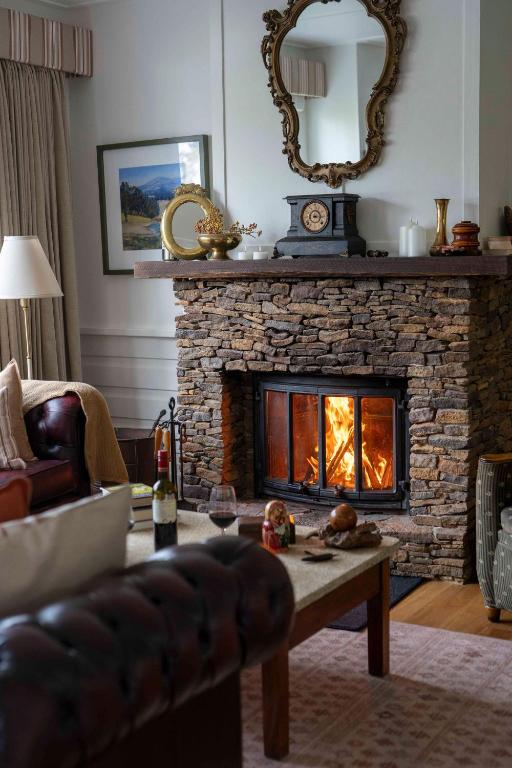 a living room with a stone fireplace and a couch at Blackheath Getaway in Blackheath