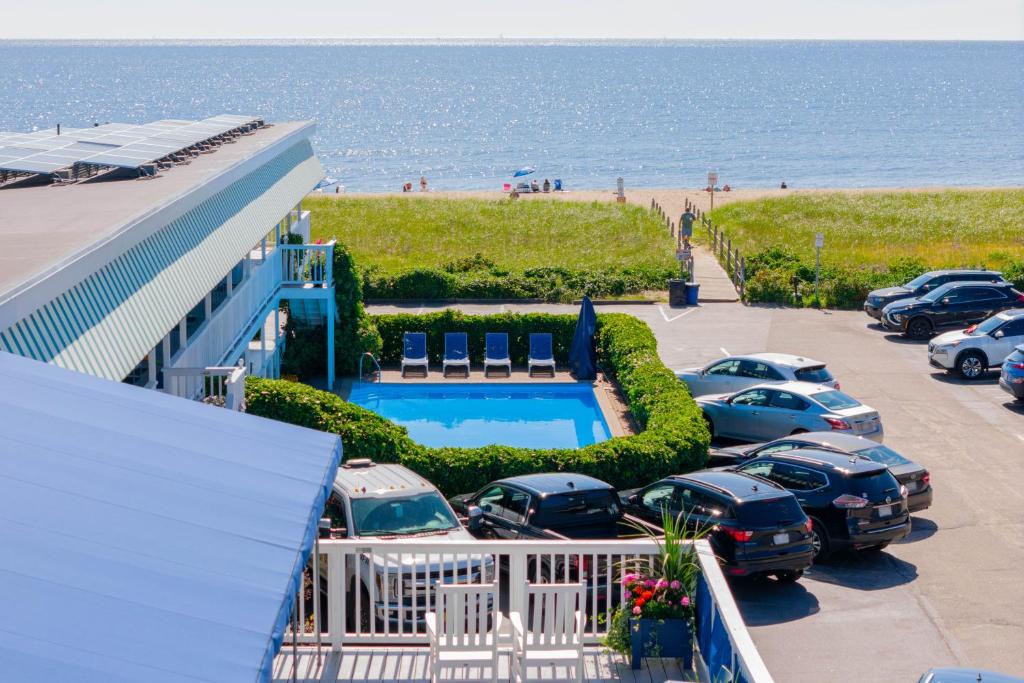a parking lot with cars parked next to the beach at The Edgewater in Old Orchard Beach