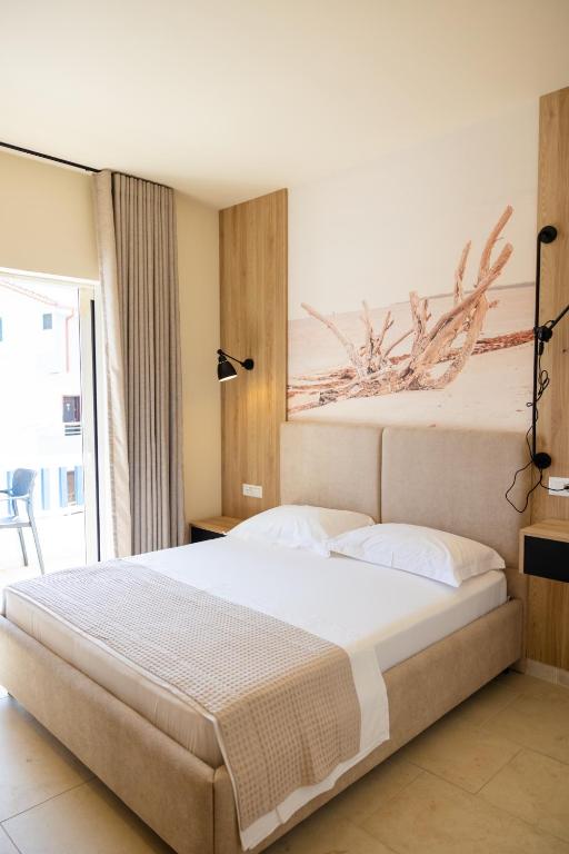 Postel nebo postele na pokoji v ubytování Sofo Hotel Dhermi