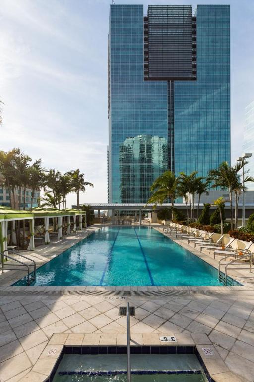 a large swimming pool in front of a tall building at Brickell Floor 31 Sea View-Free Parking by Palermo Home Miami in Miami