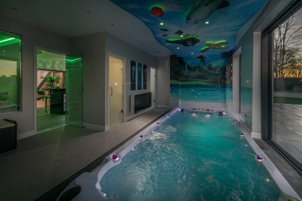 - une piscine dans une maison dotée d'un plafond rempli d'eau dans l'établissement Luxury 7 Bed Durham Mansion Pool, Spa, Cinema, à Durham