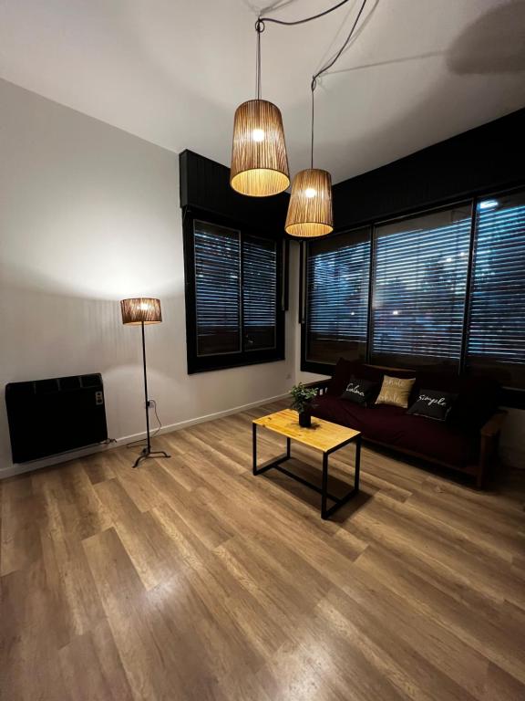 a living room with a couch and a table at Travesia Sur Hostel in El Bolsón