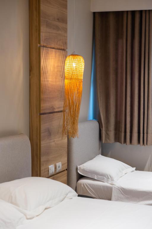 Postel nebo postele na pokoji v ubytování Sofo Hotel Dhermi