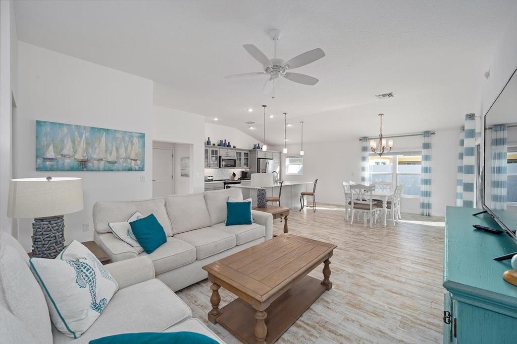 a living room with a couch and a table at Free Golf Cart & Netflix Included - 2 Mins to Brownwood Paddock-Sleeps 6 in The Villages