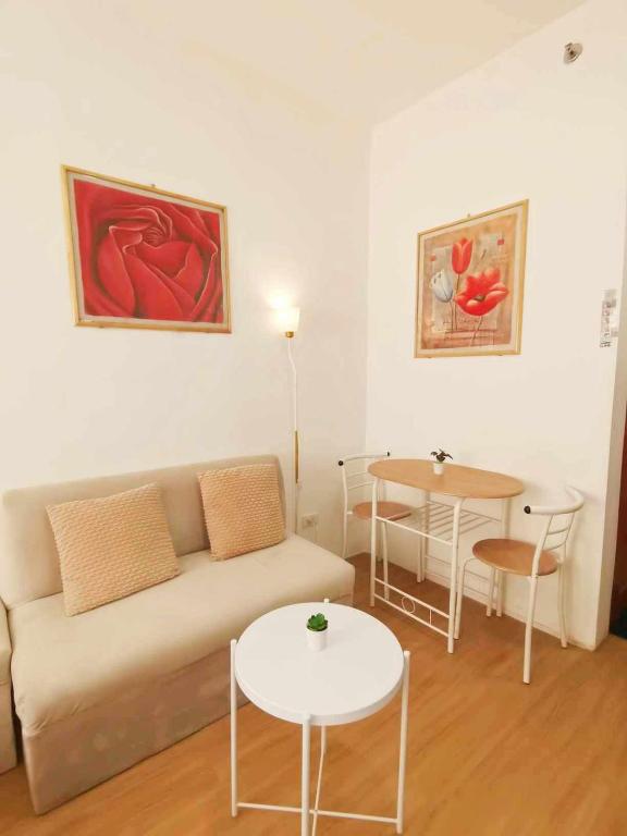 a living room with a couch and a table at Sunbeams Studio Unit in Lapu Lapu City