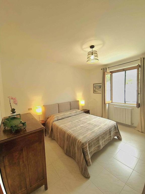a bedroom with a bed and a table and a window at Casa Braida in Muro Lucano