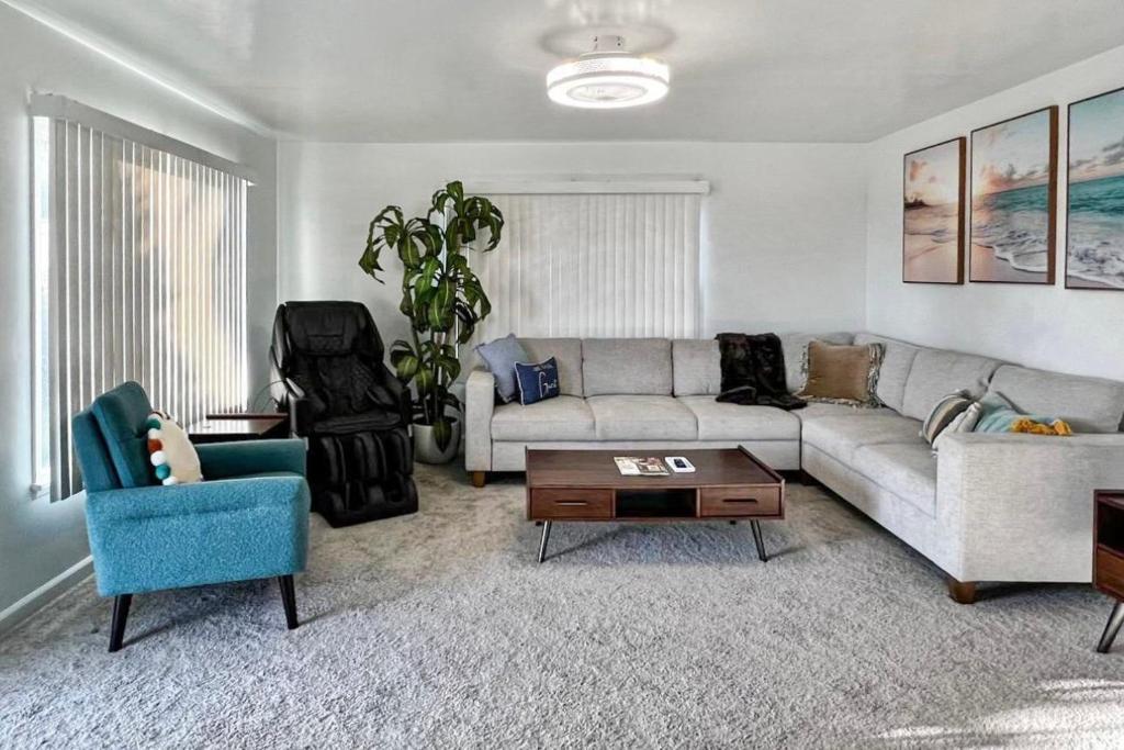 a living room with a couch and a table at Quaint Mid-Century Cottage by the Coast in Ventura