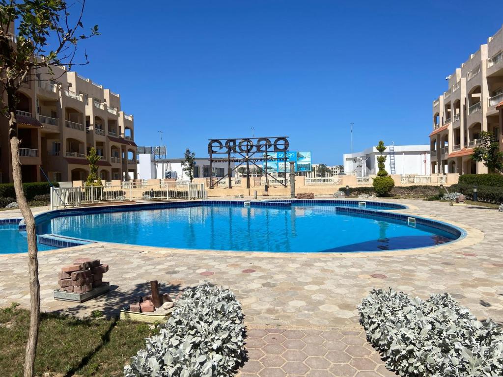 a swimming pool in the middle of a resort at Agora Sidi Abdelrahman - One Bedroom Chalet in El Alamein