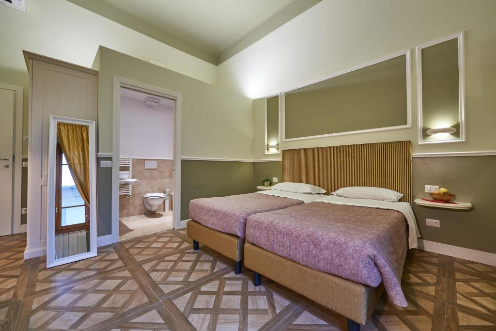 Letto o letti in una camera di B&B Le Stanze del Duomo