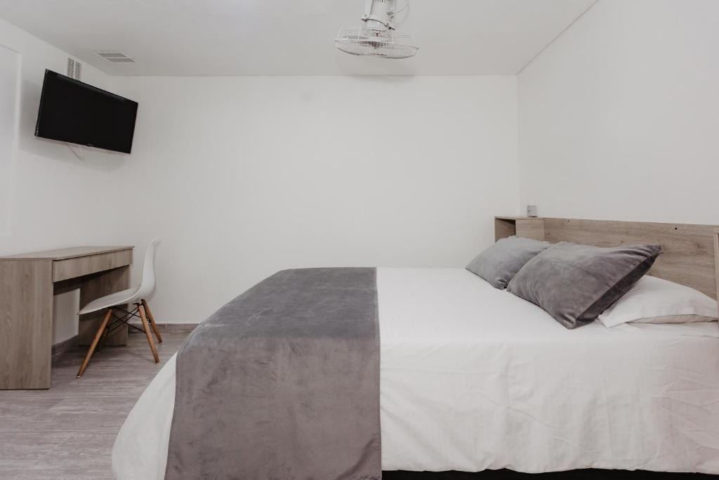 Postel nebo postele na pokoji v ubytování Hotel Plataneras Caney