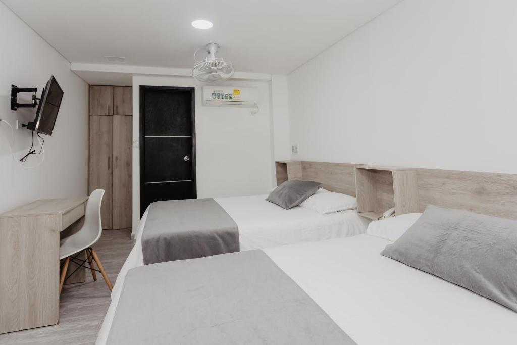 Postel nebo postele na pokoji v ubytování Hotel Plataneras Caney