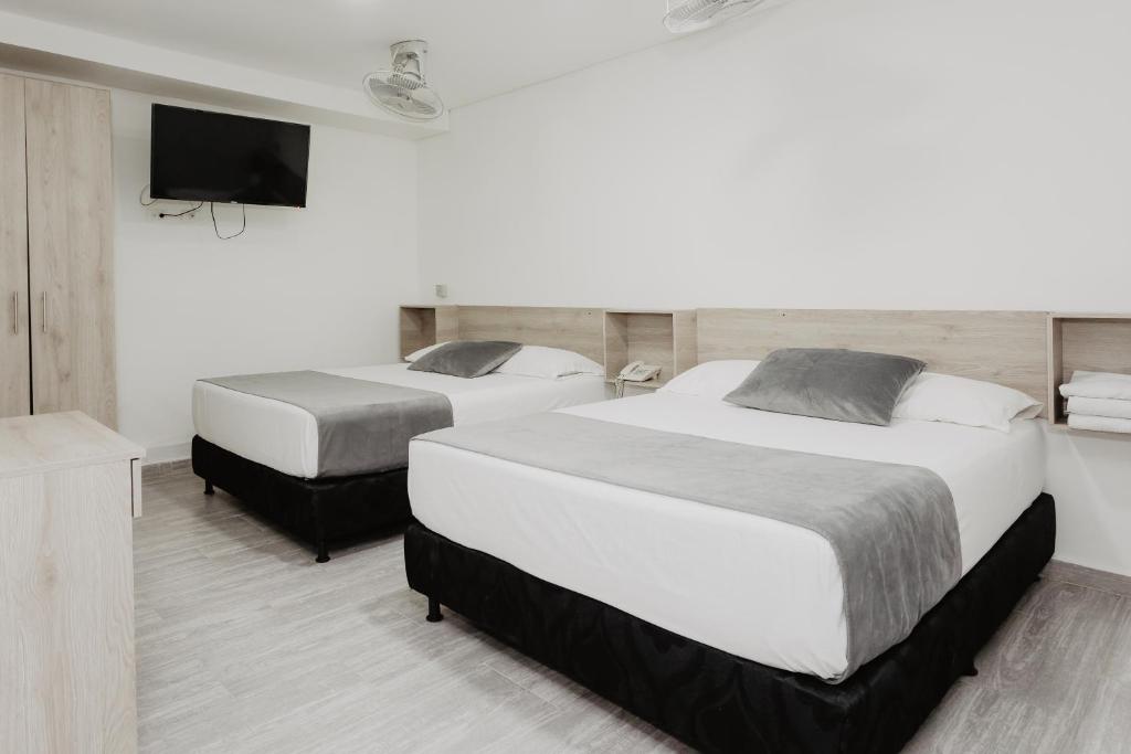 Postel nebo postele na pokoji v ubytování Hotel Plataneras Caney